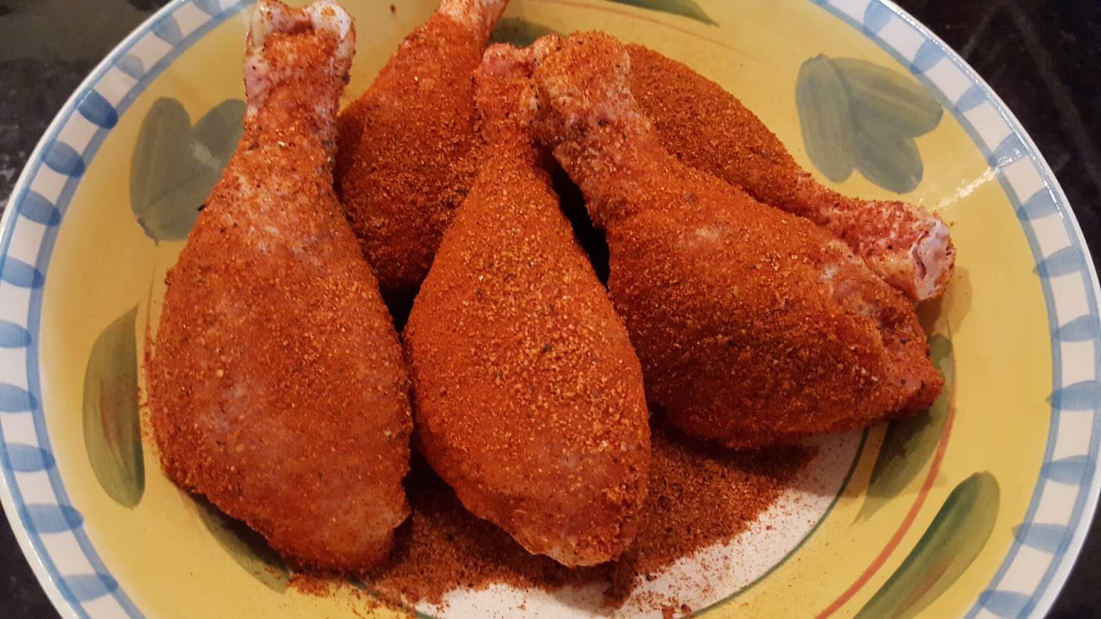 seasoned chicken legs ready for smoking on the grill