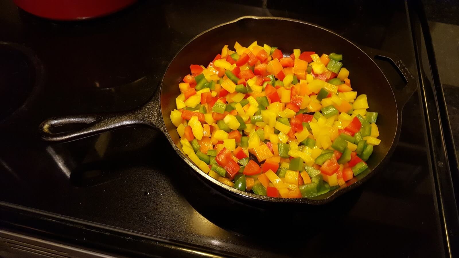 Sauteing bell peppers in a cast iron skillet