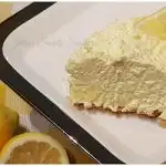 No Bake Lemon Pie slice on a serving dish garnished with a lemon slice