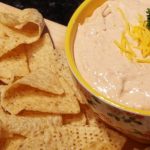 Easy Taco Dip Recipe in a bowl with tortilla chips on the side