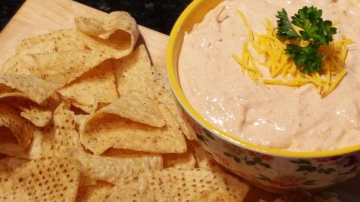 Easy Taco Dip Recipe in a bowl with tortilla chips on the side