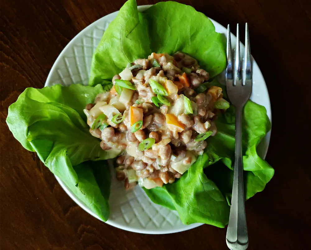bean salad on lettuce with a fork