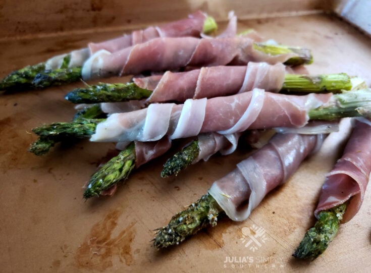 Asparagus Wrapped in Prosciutto on a sheet pan serving tray