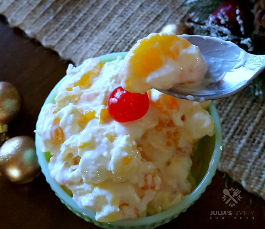 Ambrosia for Christmas dinner - served in a green dish with a cherry on top