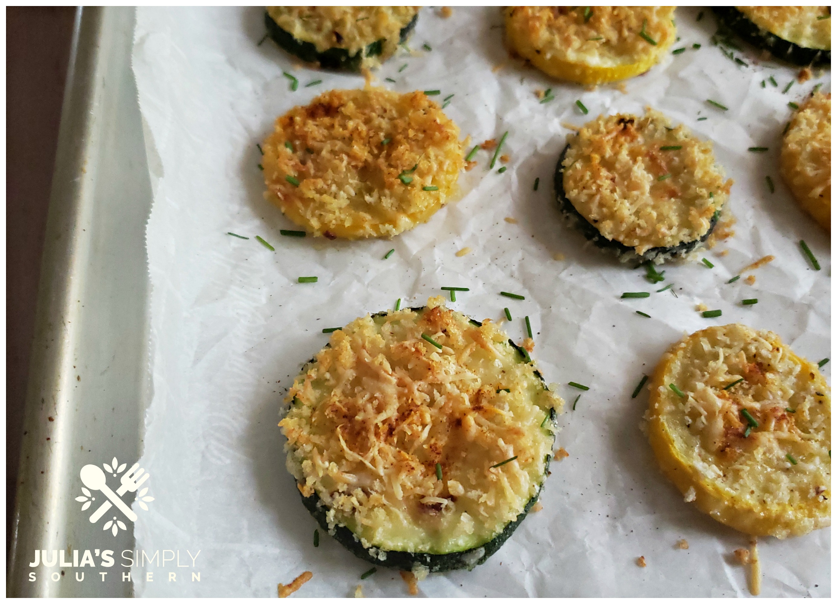 Sheet pan with baked yellow squash and zucchini rounds with Parmesan cheese that is an awesome side dish recipe