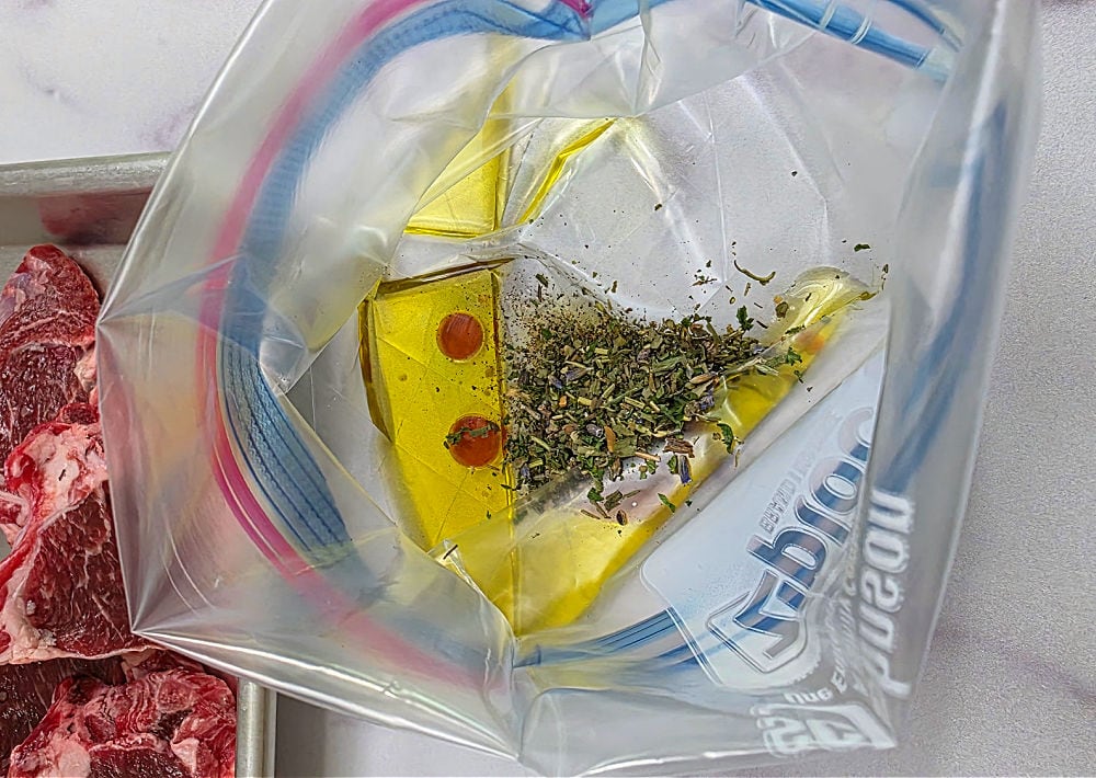 Preparing a marinade for  lamb chops in a plastic food storage bag.