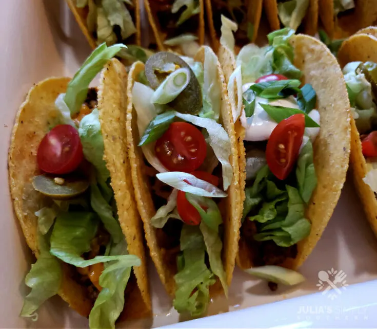 Easy Cheesy Oven Baked Tacos Recipe - So delicious with favorite toppings and sour cream