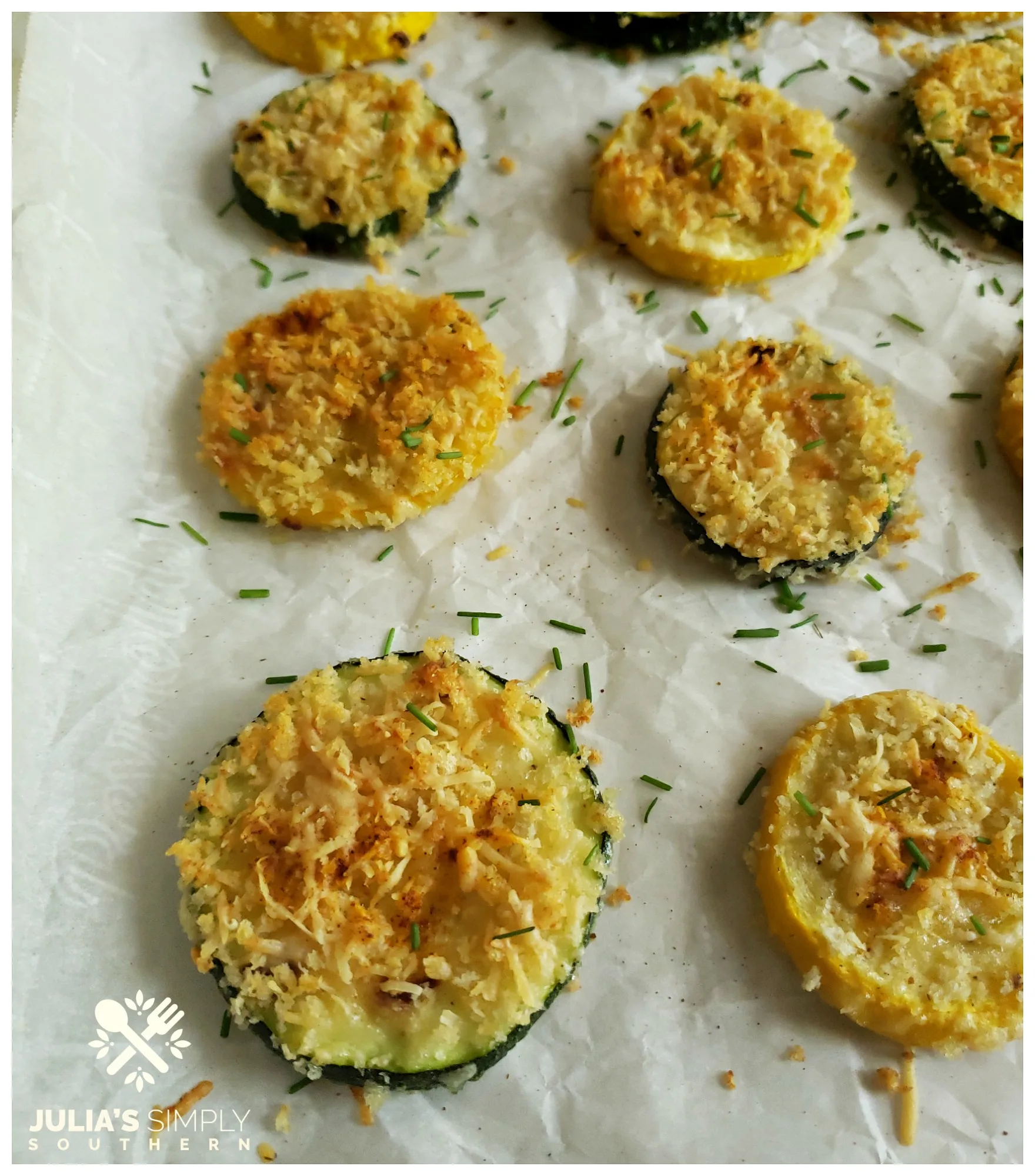 Fresh roasted summer squash with cheese on a silver baking sheet pan