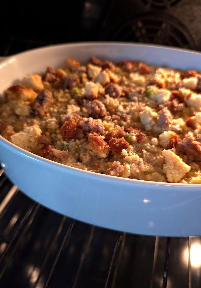 casserole of Southern cornbread dressing with sausage and apples baking in the oven