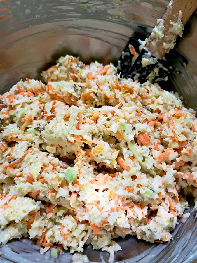silver mixing bowl with fresh homemade coleslaw