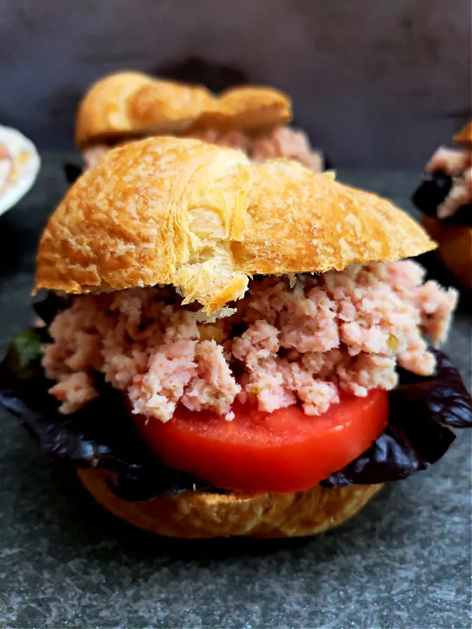 sandwich with deviled ham salad spread with lettuce and tomato.