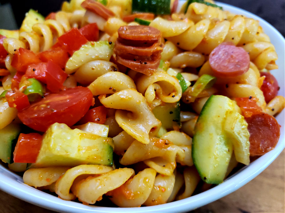 white bowl with pasta salad with veggies marinated in Italian dressing with salad supreme seasoning