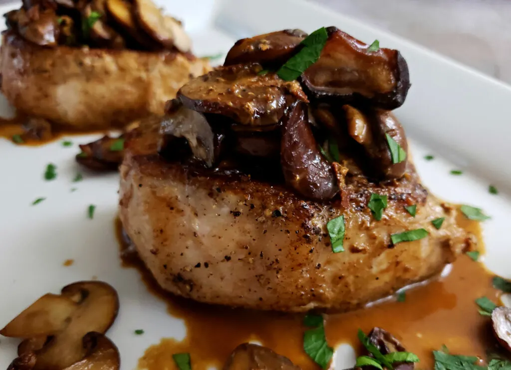 tender creamy mushrooms on top of thick pork chops