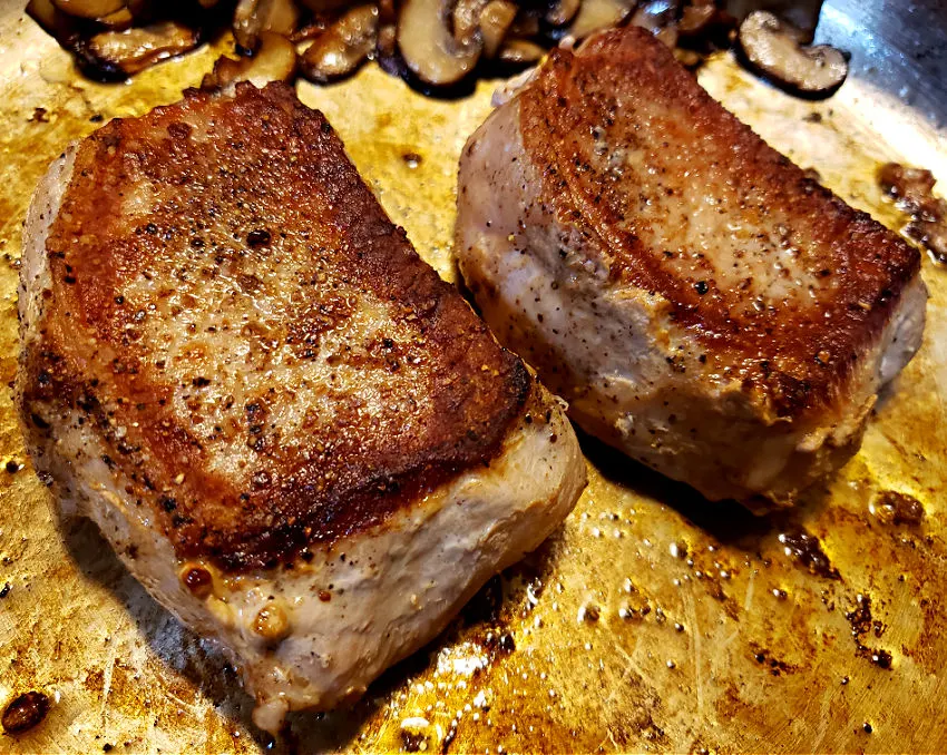 Seared pork chops in a skillet