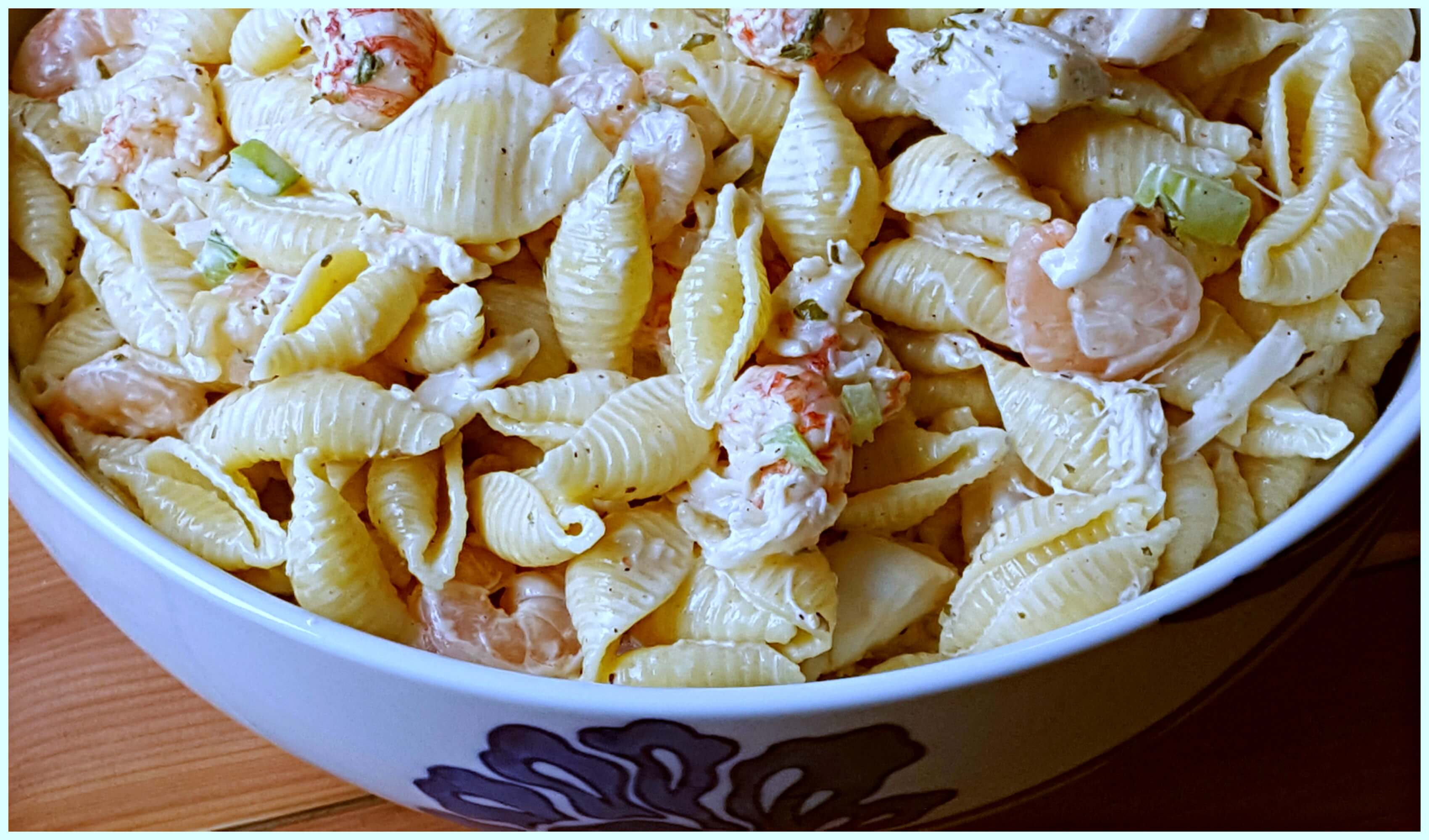 Seafood Salad with seashell pasta in a blue and white bowl