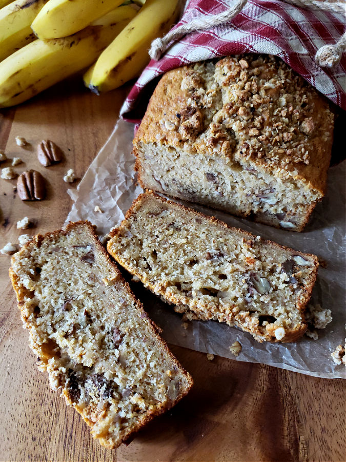 Delicious banana bread on a sheet of parchment paper next to ripe bananas.
Banana Bread Recipe with Self Rising Flour