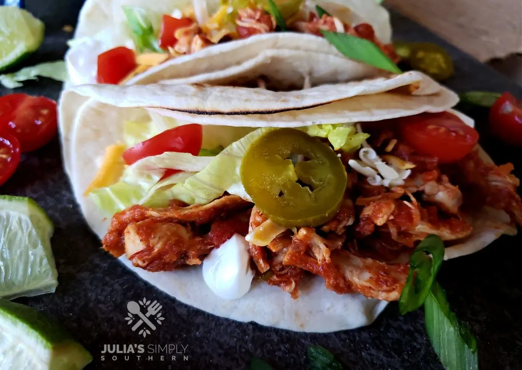 Soft chicken tacos with slow cooker shredded chicken and toppings