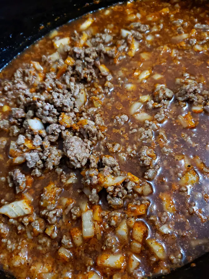 Hot dog chili simmering in a slow cooker