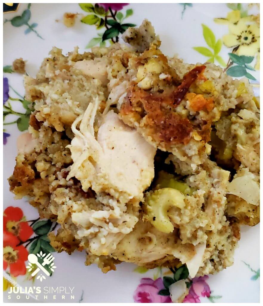 slow cooker chicken and cornbread dressing casserole recipe served on a pretty floral china plate