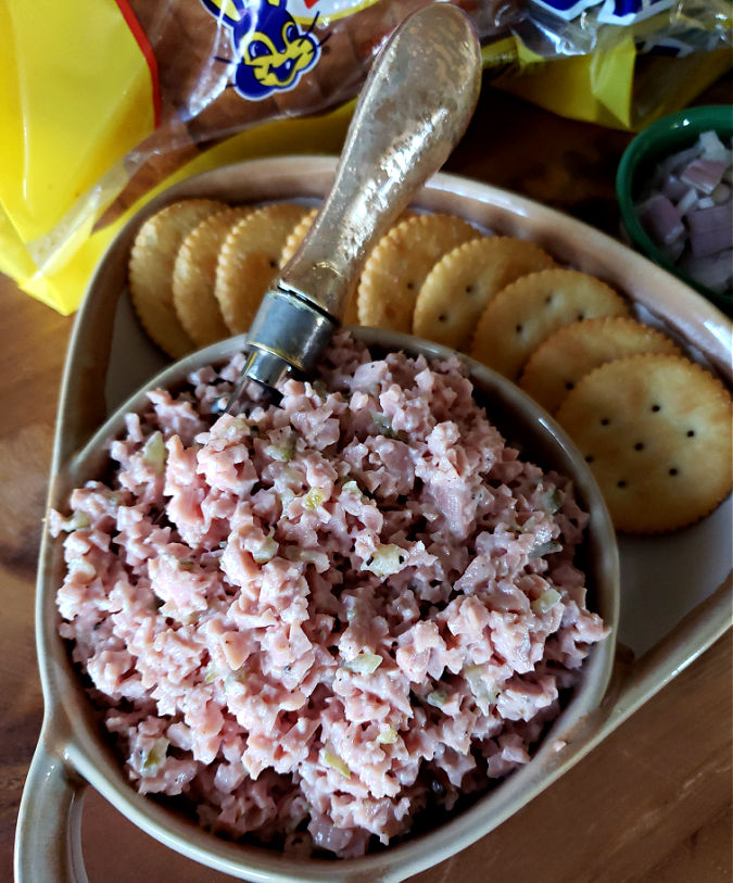 how to make bologna salad - baloney salad mixture in a serving bowl with crackers
