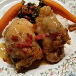 Braised Chicken Thighs on a dinner plate with carrots and greens