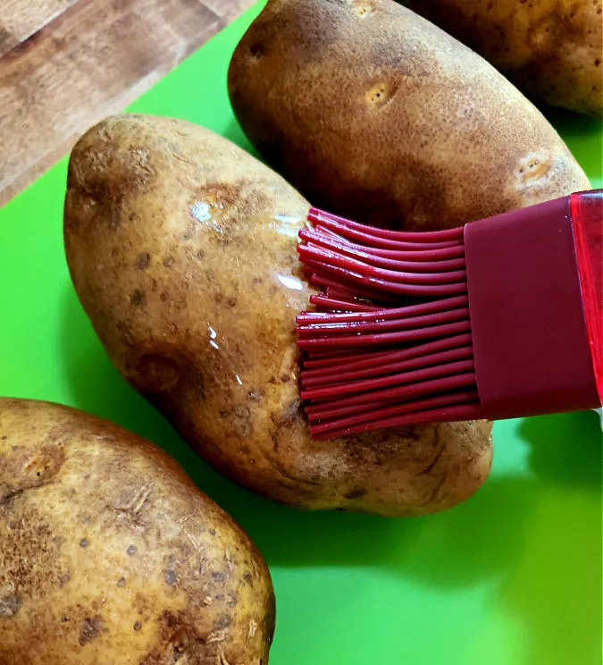 brush potatoes with oil before baking