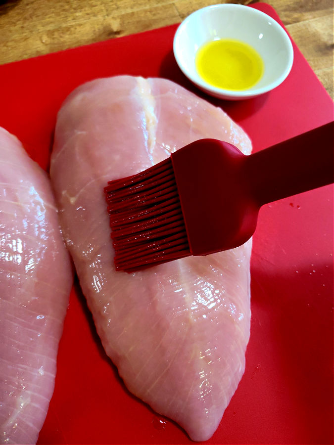 brush skinless turkey breasts with olive oil