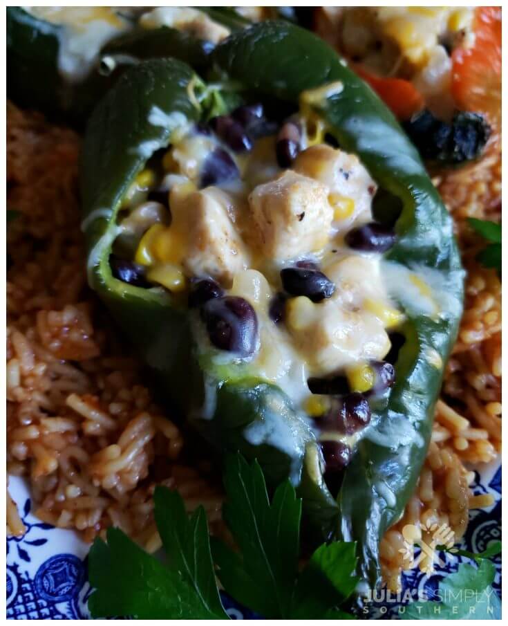 Fresh baked poblano pepper stuffed with chicken, cheese, corn and black beans and served on a bed of Spanish rice. The best stuffed pepper recipe with poblanos.