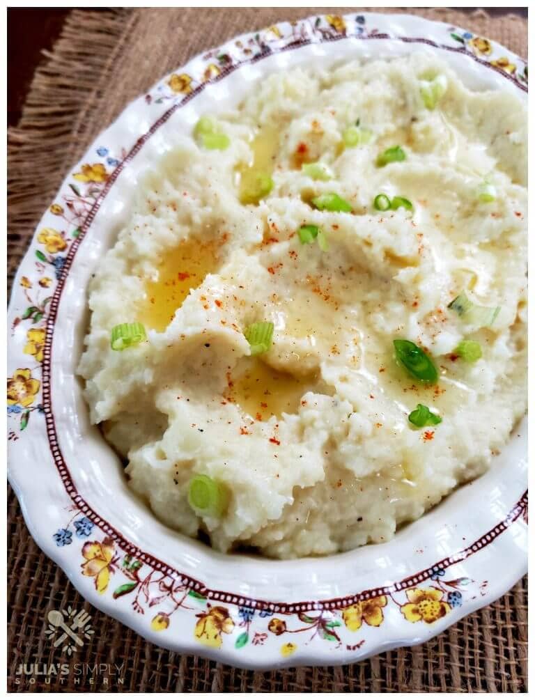 Cauliflower mashed mock potatoes recipe topped with melted butter and scallions