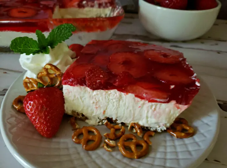 Strawberry jello pretzel salad dessert on a white plate