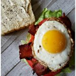 Best BLT Sandwich Recipe with fried egg for breakfast. The perfectly cooked egg with runny yolk sits on top of crispy bacon, crisp lettuce and a fresh vine ripe tomato on toasted bread for the ultimate breakfast.