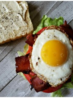 Best BLT Sandwich Recipe with fried egg for breakfast. The perfectly cooked egg with runny yolk sits on top of crispy bacon, crisp lettuce and a fresh vine ripe tomato on toasted bread for the ultimate breakfast.