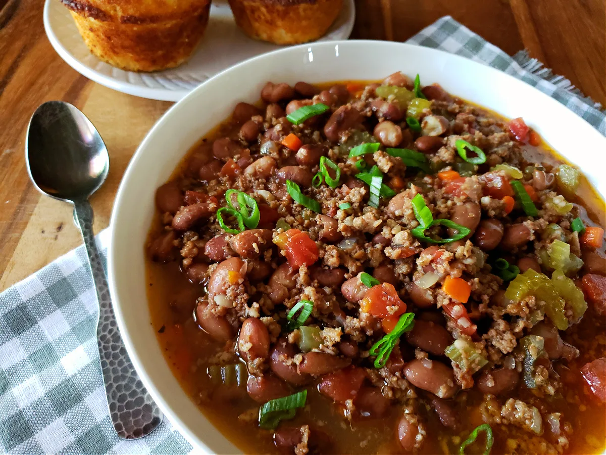 Cranberry Beans with Sausage in a white bowl