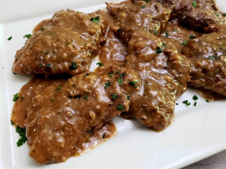 Crock Pot Beef Cube Steaks and Homemade Gravy-no packets- tender steak on white platter