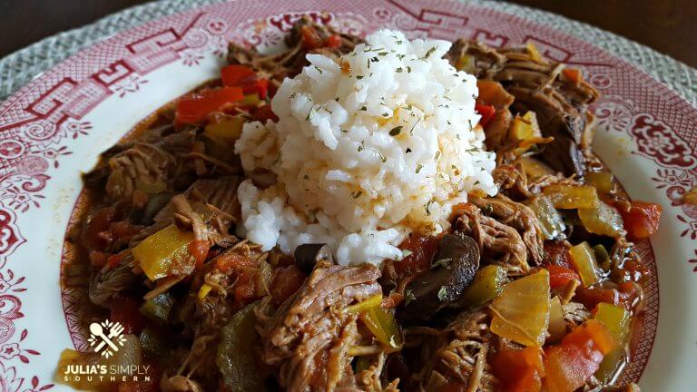 Crock Pot Fiesta Beef on a red and white china plate with rice