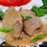 Crock Pot Pork Roast with Gravy on a bed of mashed potatoes with a cottage cheese salad