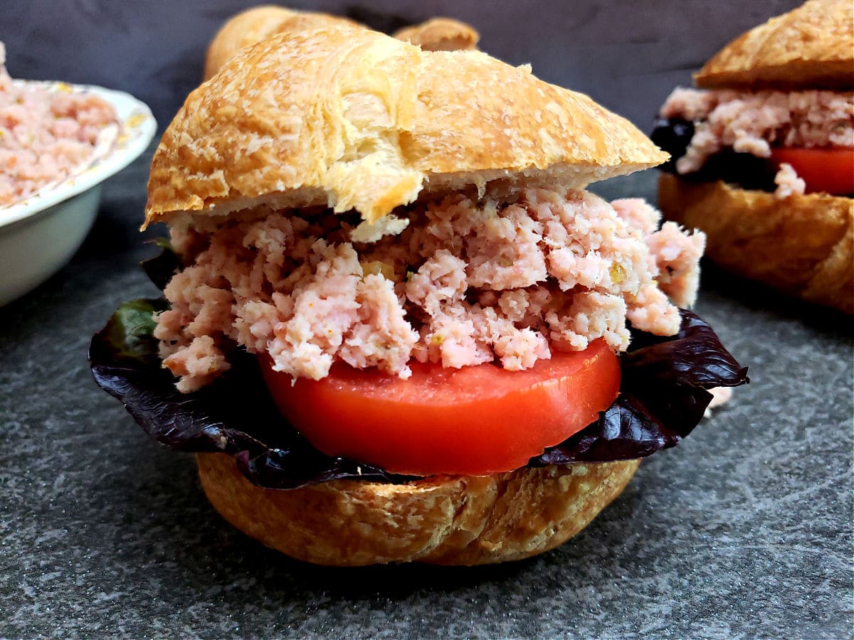 Easy homemade deviled ham recipe served on a flaky croissant with purple lettuce and ripe red tomato slice. A copycat of the Underwood canned deviled ham spread.