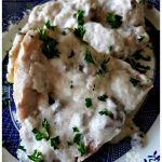 Tender baked pork chops smothered in cream of mushroom soup recipe garnished with parsley