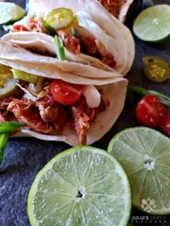 Easy Crock Pot Chicken Tacos Recipe in soft flour tortillas with favorite taco toppings