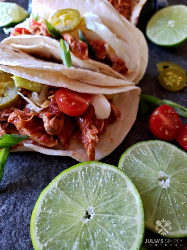 Easy Crock Pot Chicken Tacos Recipe in soft flour tortillas with favorite taco toppings