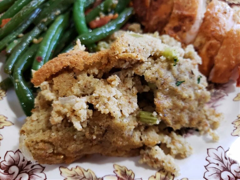 Easy Crock Pot cornbread dressing recipe on a Thanksgiving plate with roasted turkey and green beans