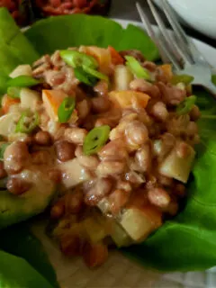 The best pork and bean salad recipe served on a bed of lettuce leaves
