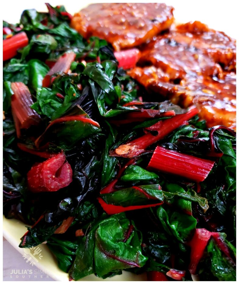 Amazing Swiss Chard Recipe - easy and healthy vegetable side dish, pictured on a platter with pork chops