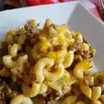 Ground Beef Casserole on a white plate with red and white napkins