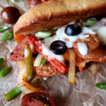 Best Italian Sausage and peppers sandwiches with cheese on toasted sub rolls