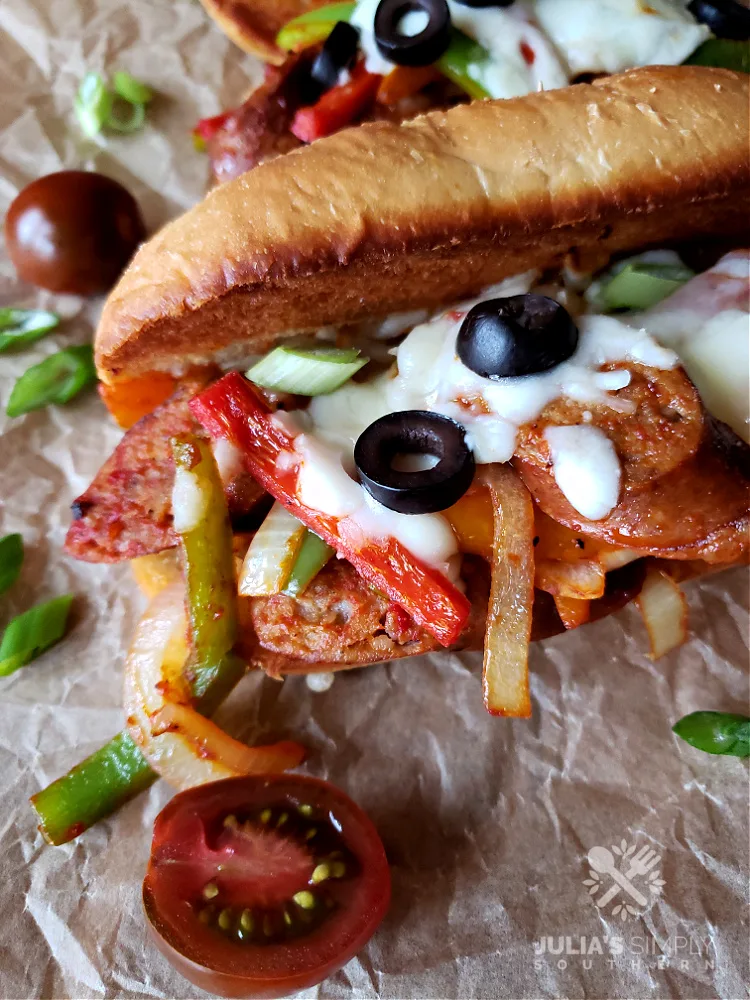 Best Italian Sausage and peppers sandwiches with cheese on toasted sub rolls