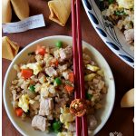 Low Carb Cauli Pork Fried Rice in a bowl with chopsticks and fortune cookies - Easy Recipe