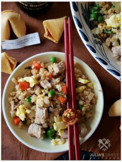 Low Carb Cauli Pork Fried Rice in a bowl with chopsticks and fortune cookies - Easy Recipe