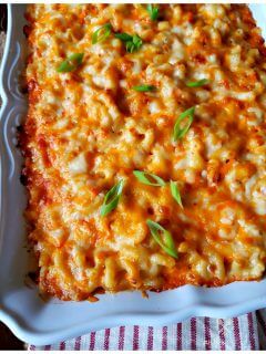 Southern Macaroni & Cheese casserole in a white baking dish garnished with scallions