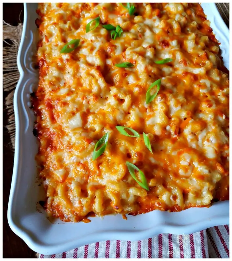 Southern Macaroni & Cheese casserole in a white baking dish garnished with scallions